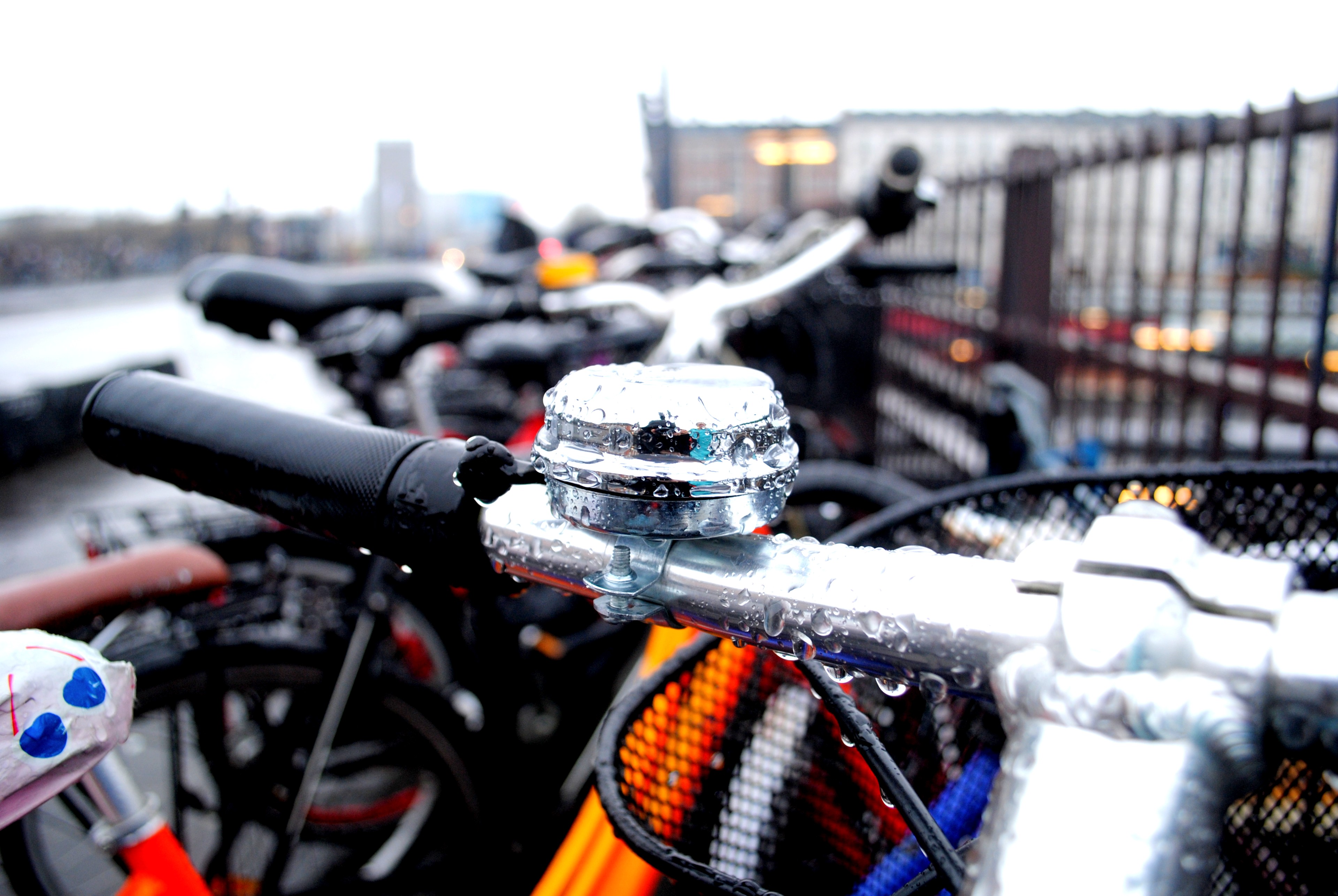 A bicycle bell beaded with raindrops